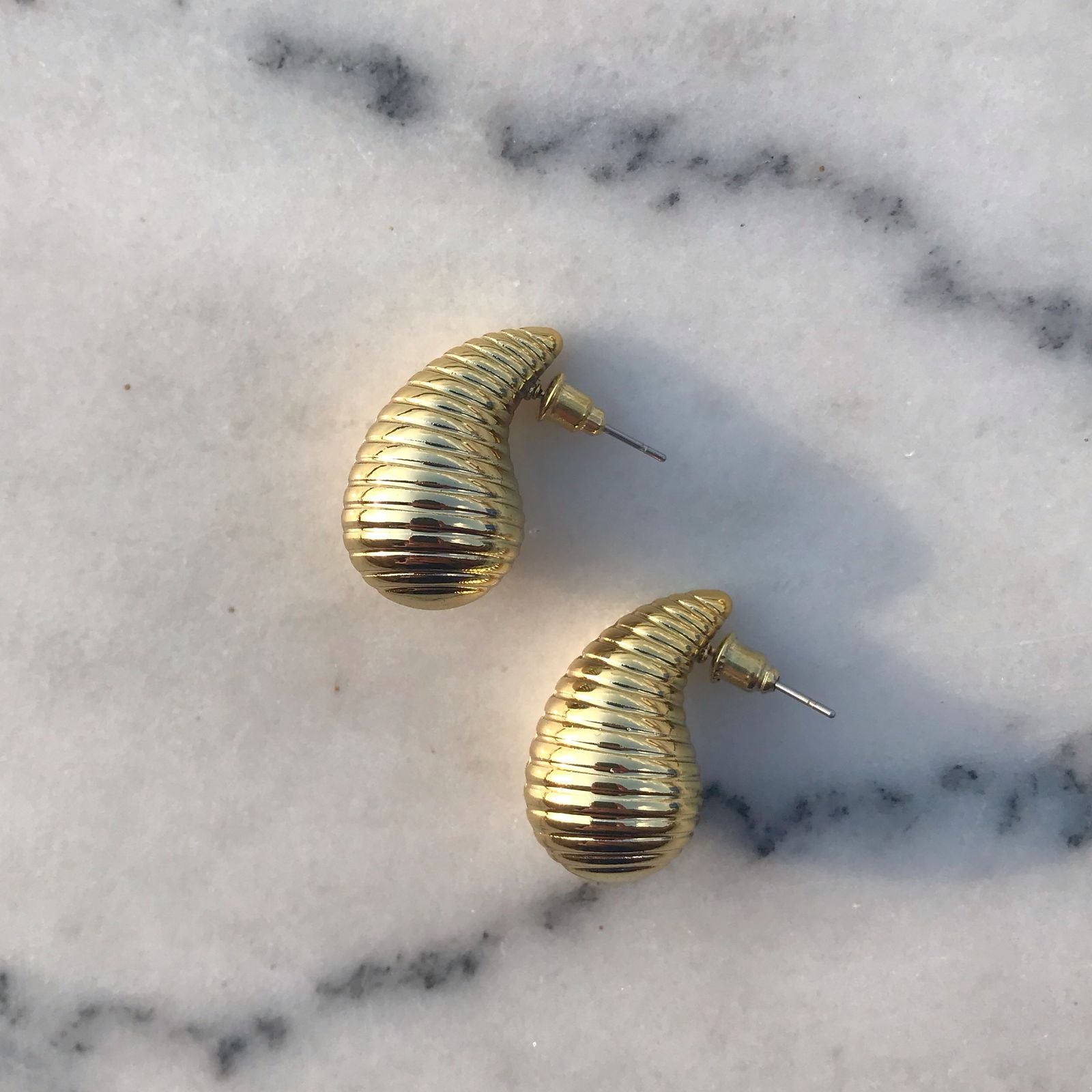 Dove studs side on marble background
